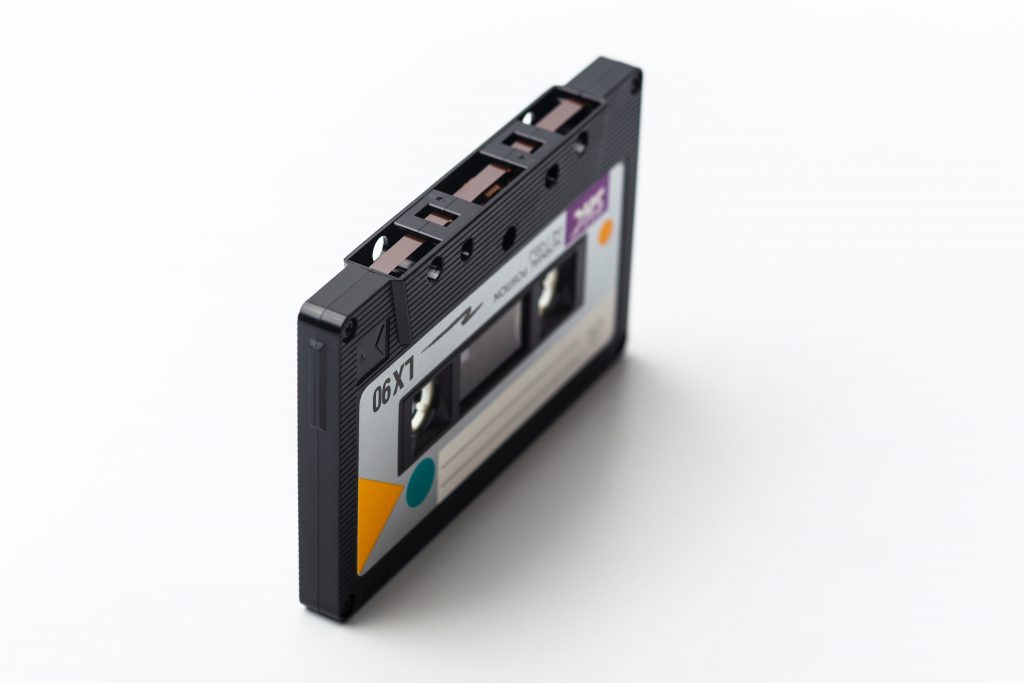 Image of a cassette tape with colourful nineties themed label