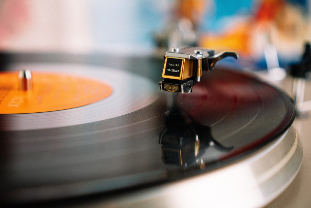 Image of a vinyl record with an orange label